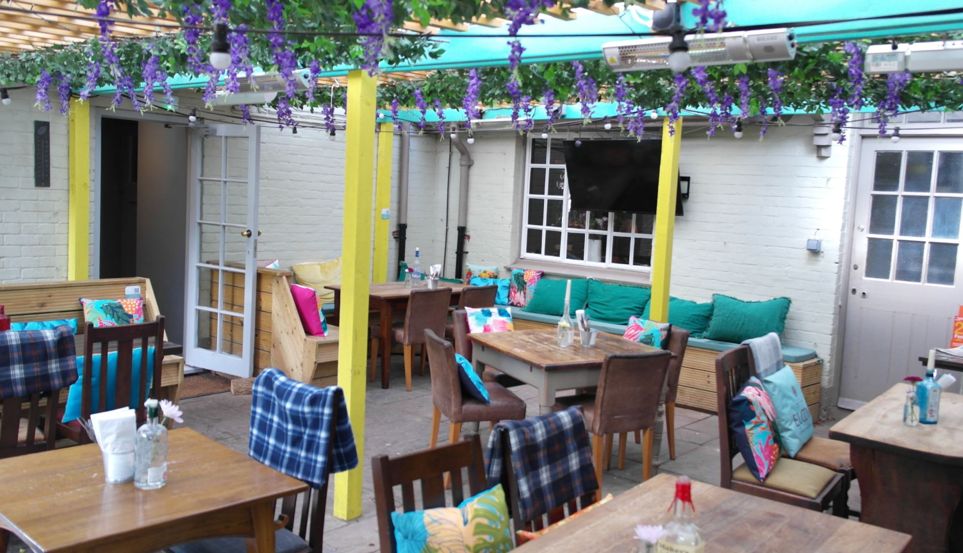 Outside heated covered terrace with flowers at the Thomas Lord in West Meon, Hampshire near Petersfield
